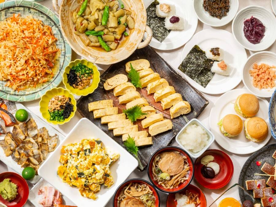 A variety of dishes and food items arranged on a table.