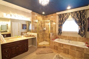 A luxurious bathroom with a large vanity, a walk-in shower, and a freestanding bathtub. - Southern Grace Bed & Breakfast (Brandenburg)