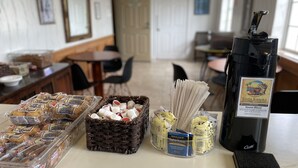 A breakfast buffet with muffins, pastries, and coffee options. - Inn On The Beach (Ventura)