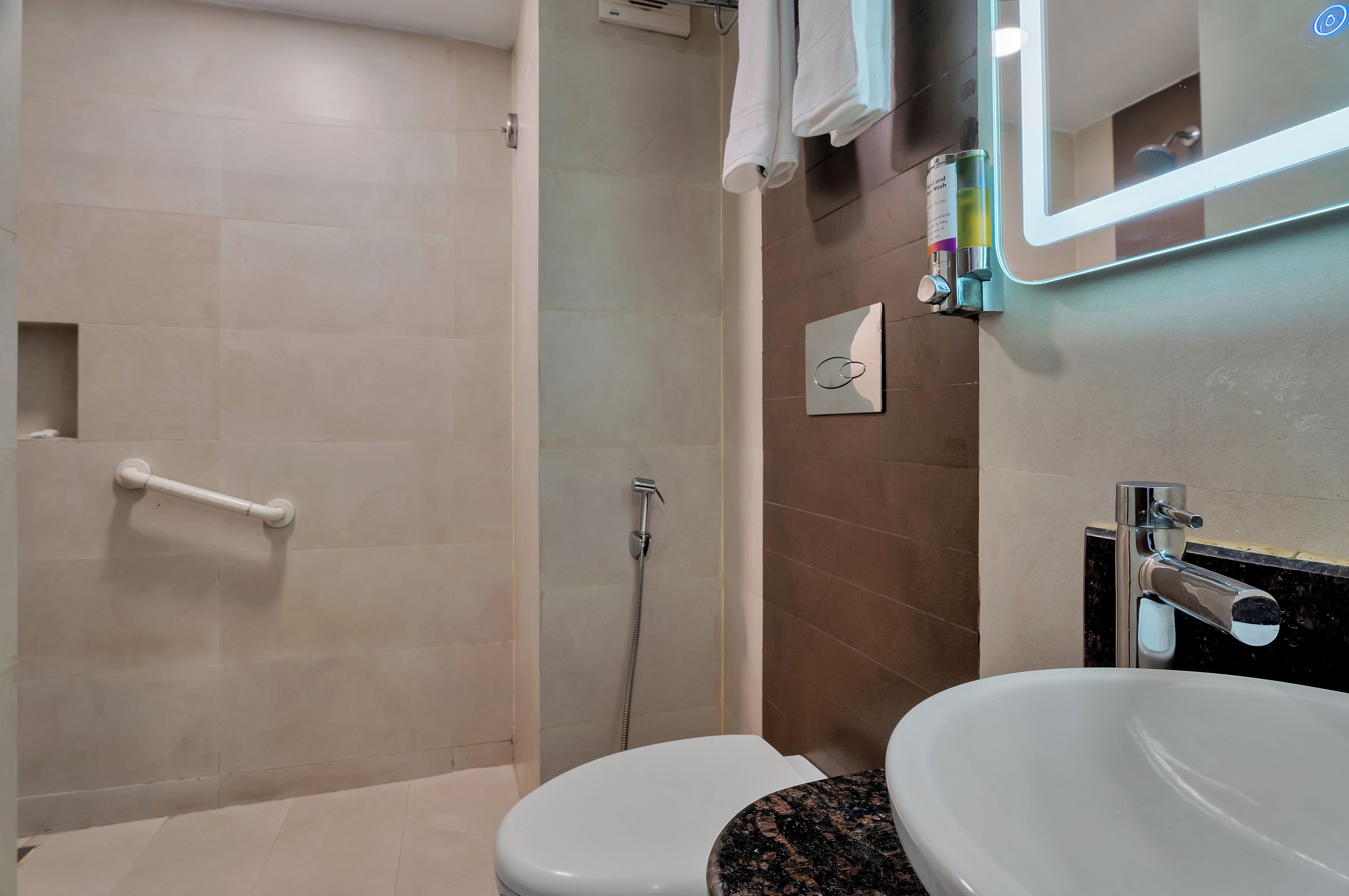 A bathroom with a shower, a toilet, and a sink.