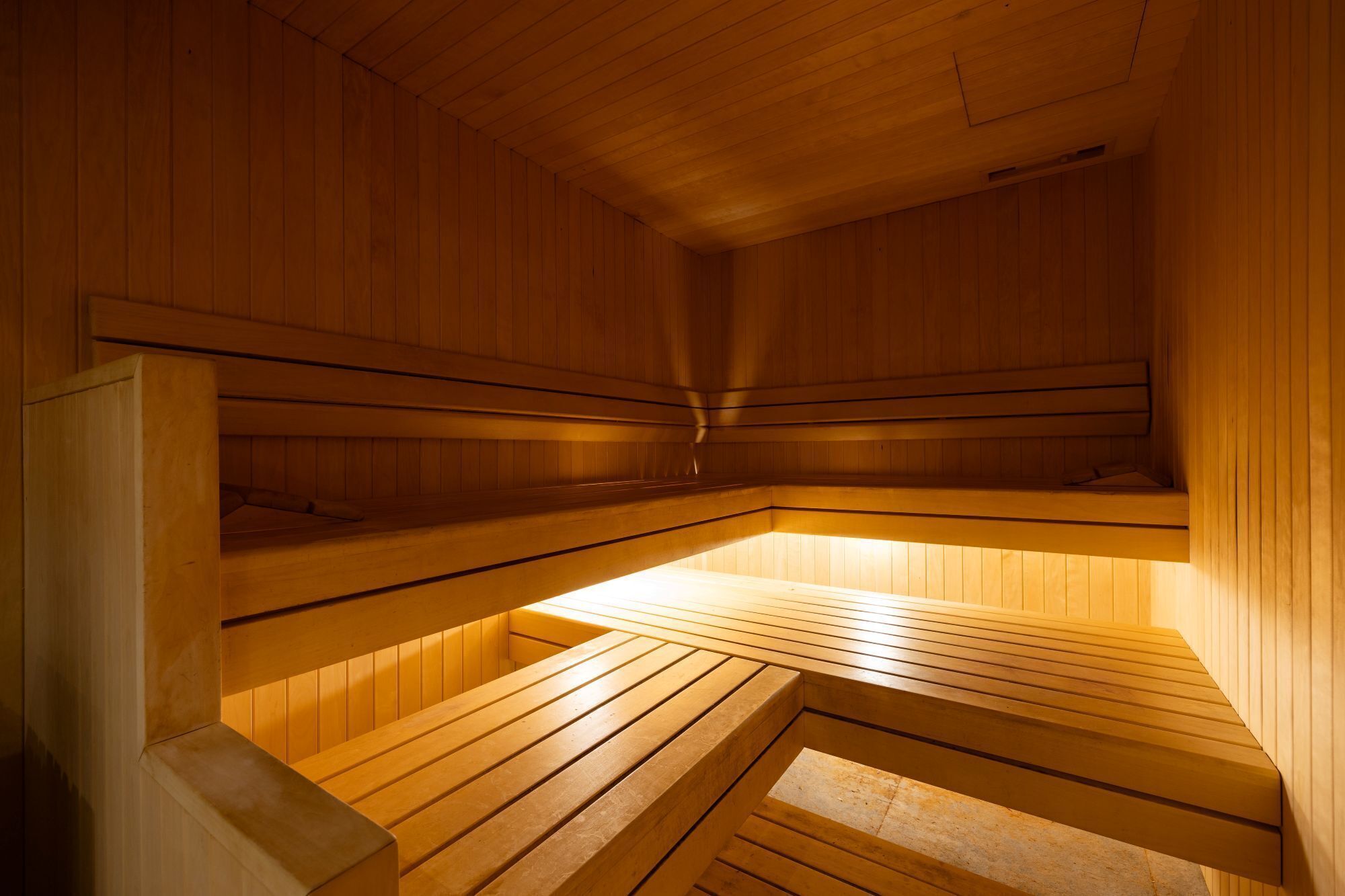 A sauna with wooden benches and walls.