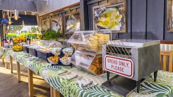 A buffet setup with various food items and a sign indicating 'BREAD ONLY, PLEASE'.