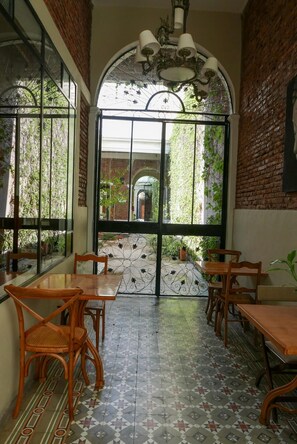 Enjoy communal dining in a traditional space with a semi-circular seating area and brickwork walls.