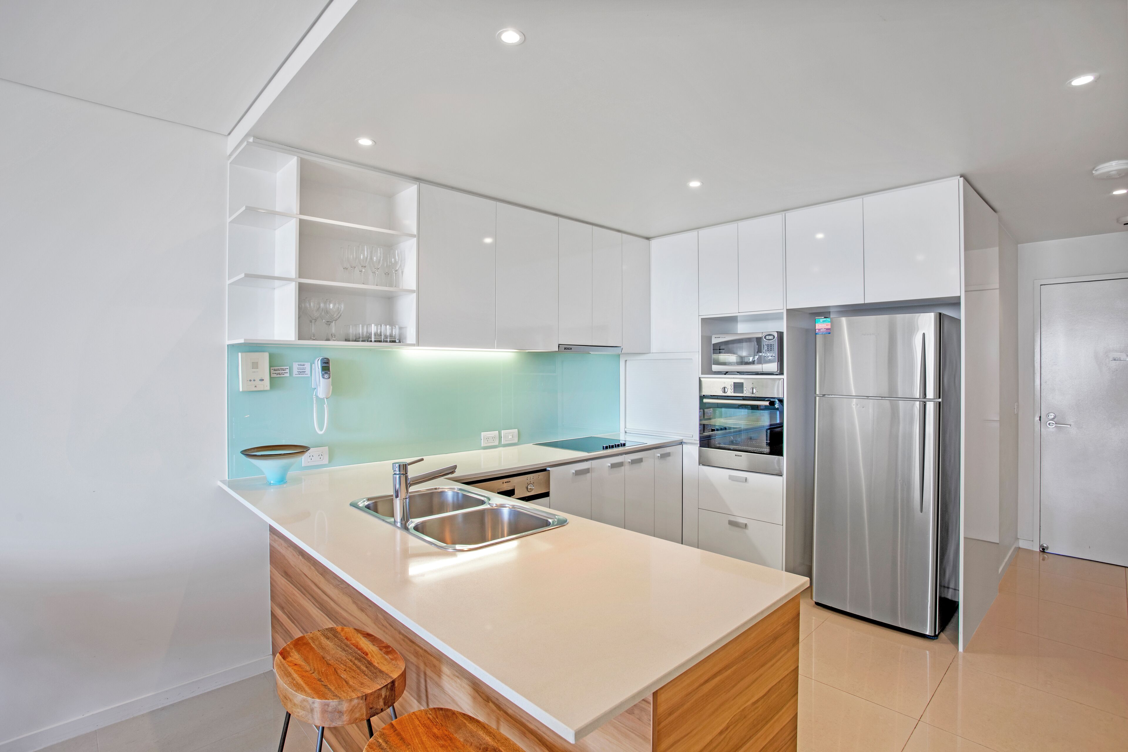 A modern kitchen with a central island, stainless steel appliances, and a minimalist design.