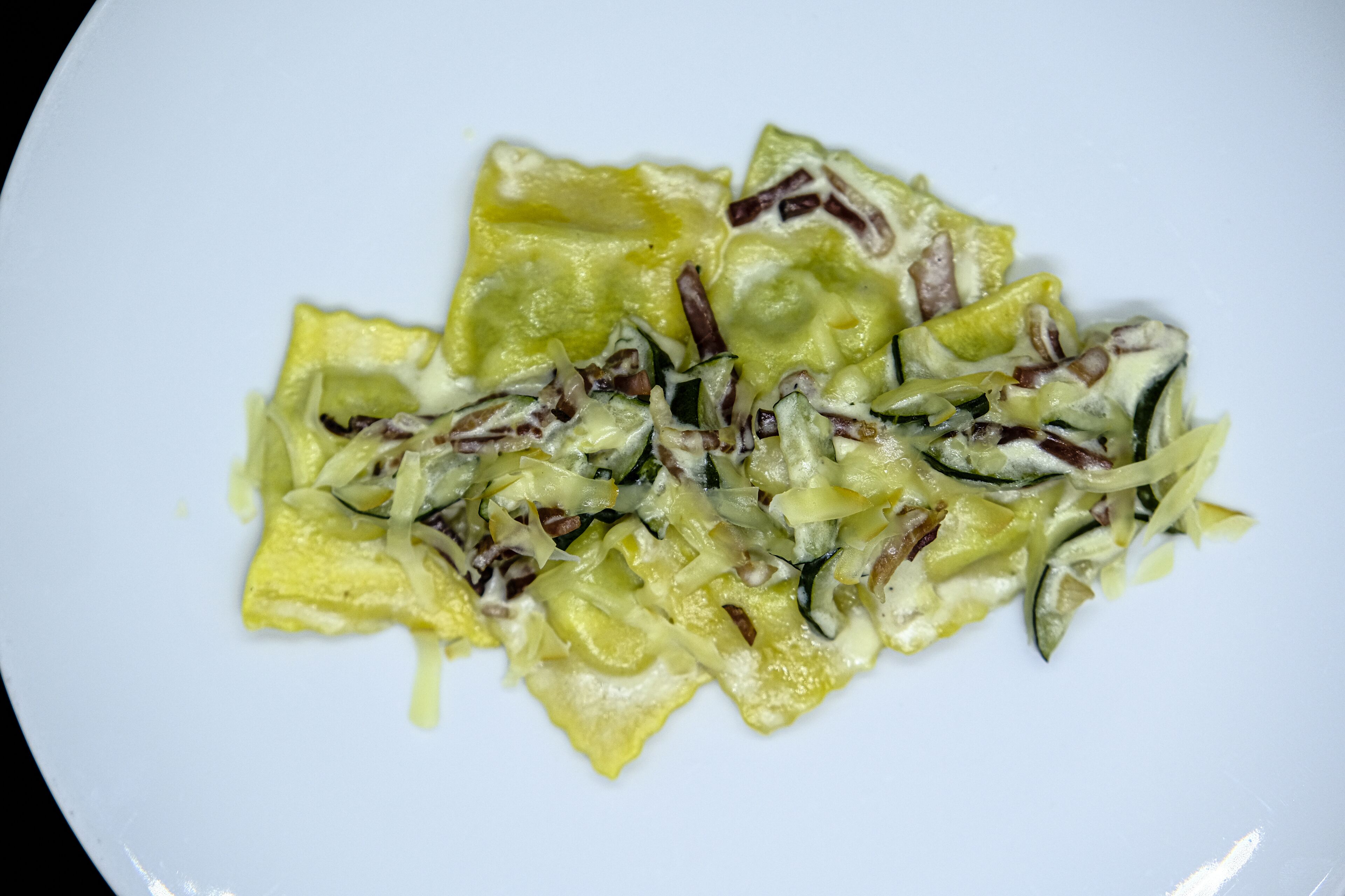 A plate of food with a yellow sauce and shredded vegetables.