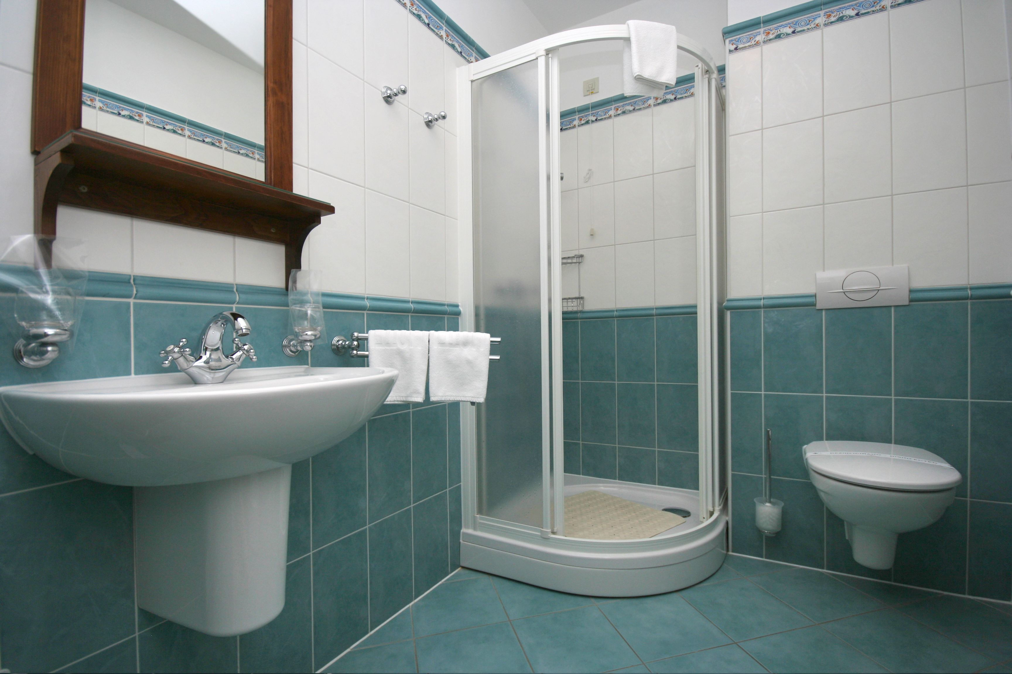 A bathroom with a sink, toilet, and shower.