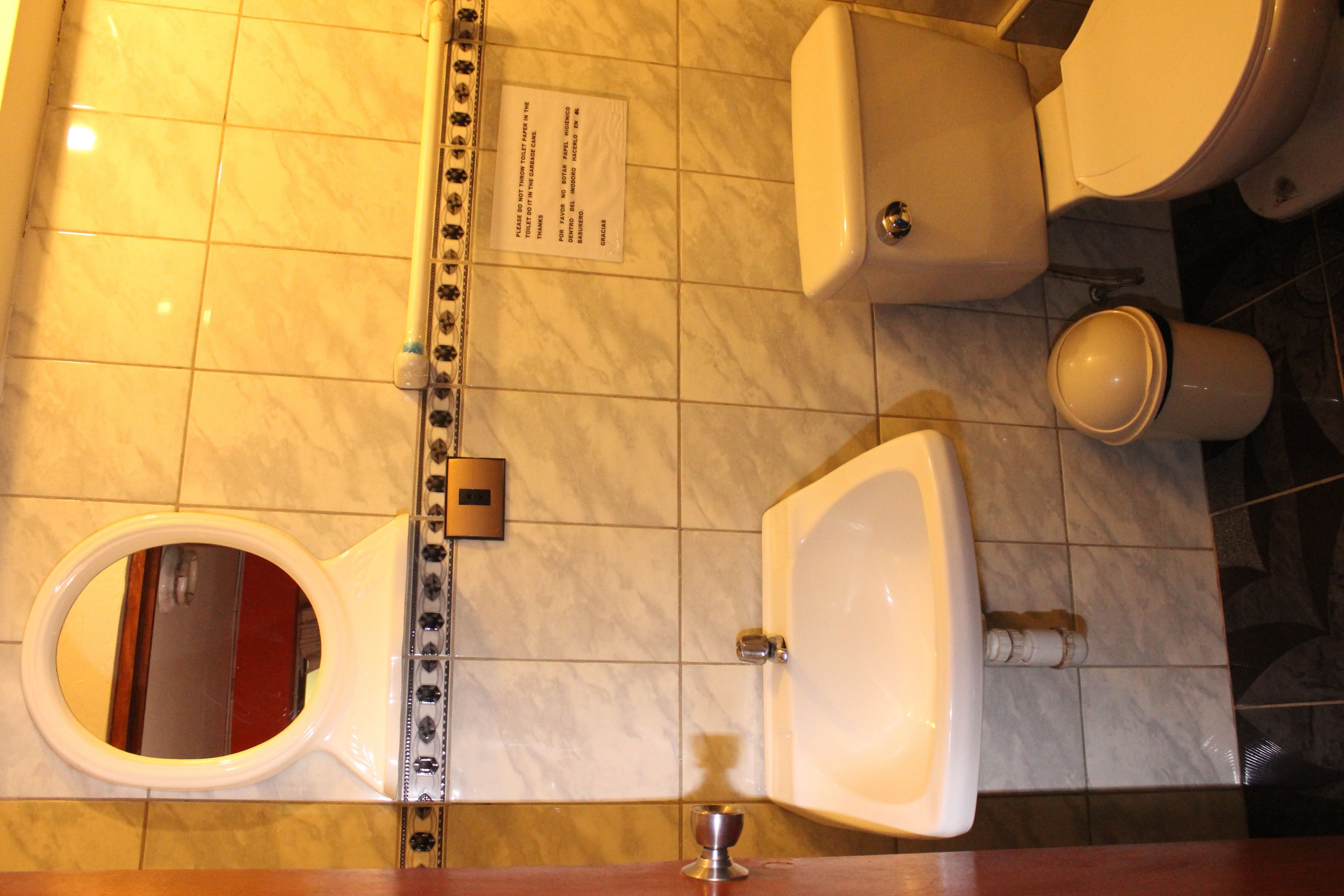 A bathroom with a toilet, bidet, and sink.