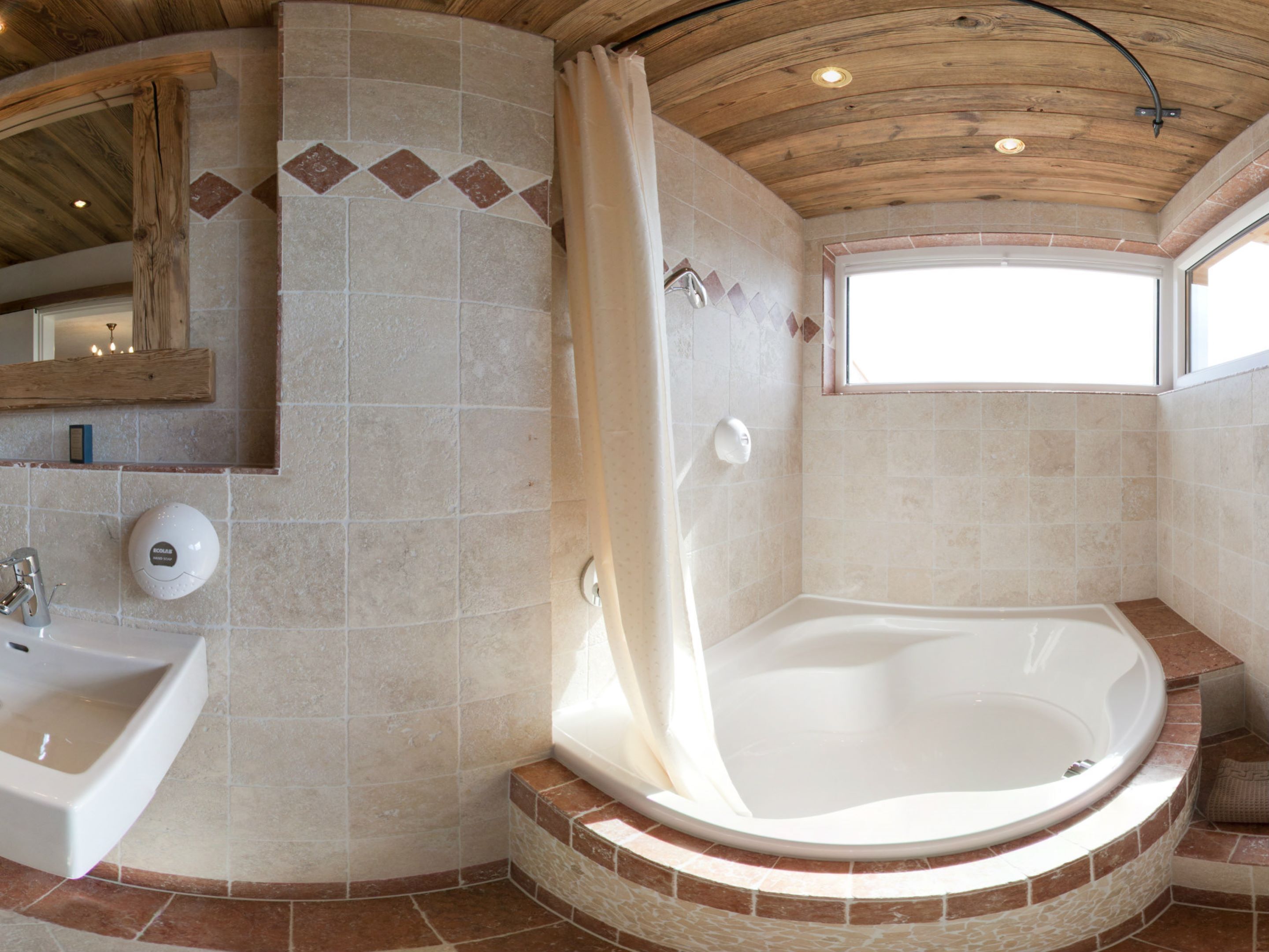 A bathroom with a bathtub, a sink, and a shower.