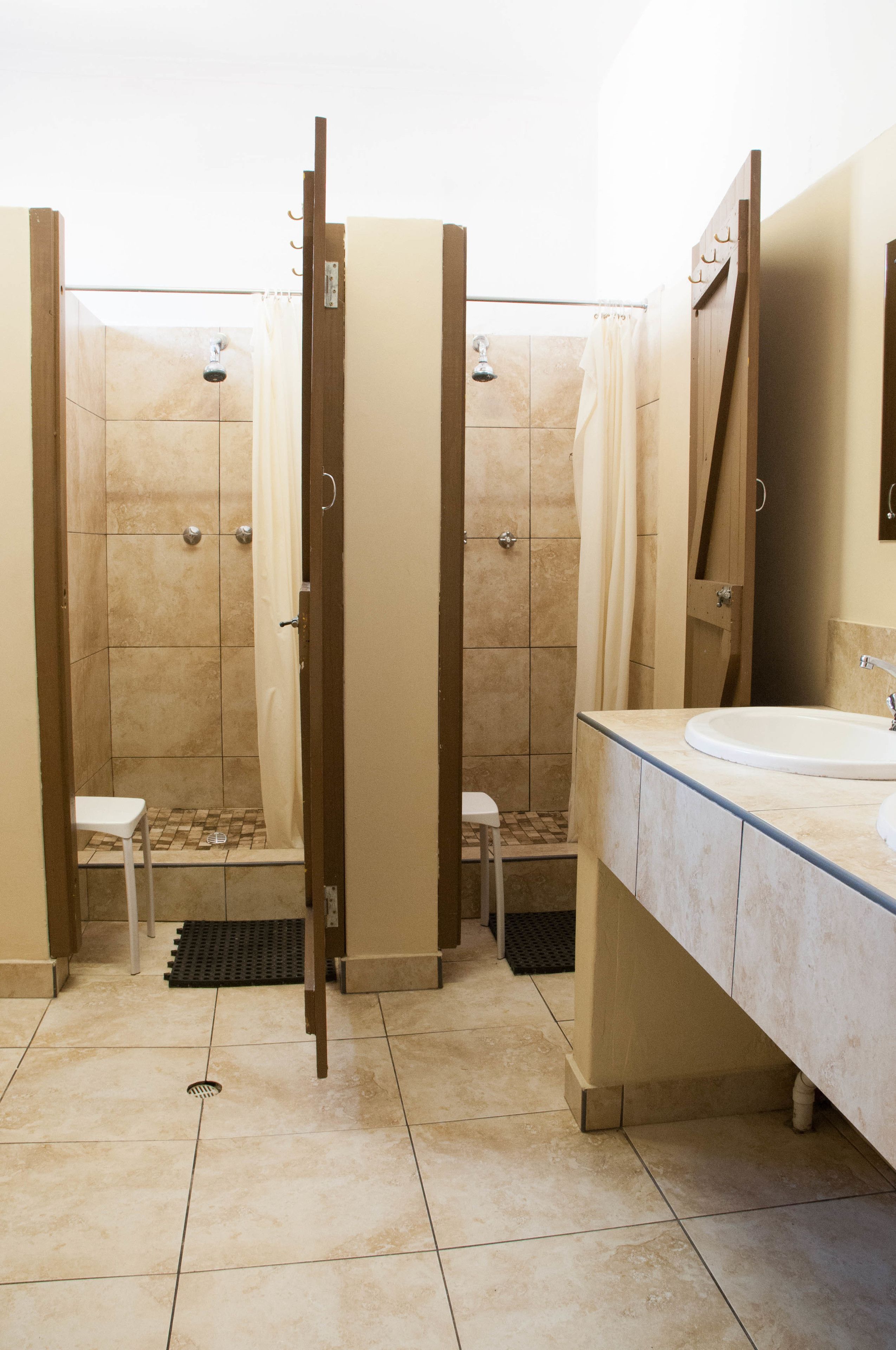 A bathroom with a shower, toilet, and sink.