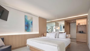 A modern hotel room with a large bed, a seating area, a coffee machine, and a large window. - Hotel de l'ITHQ (Montreal)