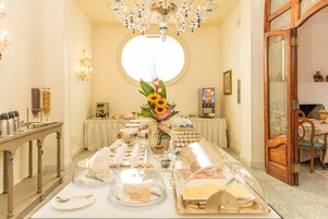 Un bufé de desayuno con diversas opciones de comida y un centro de mesa floral.