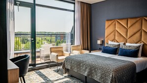 Une chambre d’hôtel dotée d’un grand lit, donnant sur un balcon et présentant un design moderne.