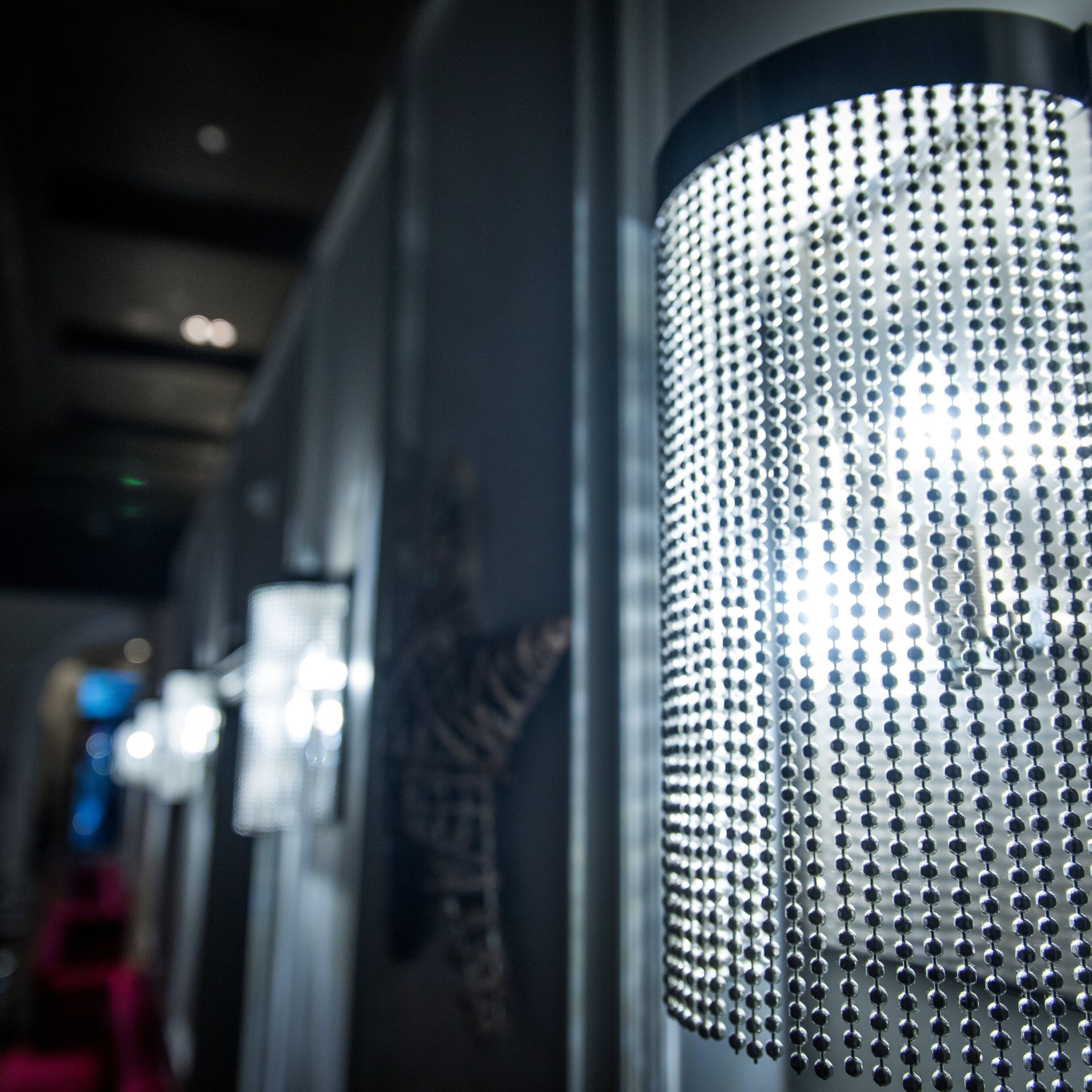A close-up of a metallic, bead-like light fixture.