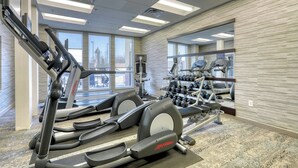 A gym with treadmills, weight machines, and dumbbells. - Courtyard by Marriott York (York)