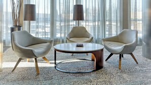 A modern living room with two armchairs, a coffee table, and two floor lamps. - Courtyard by Marriott York (York)