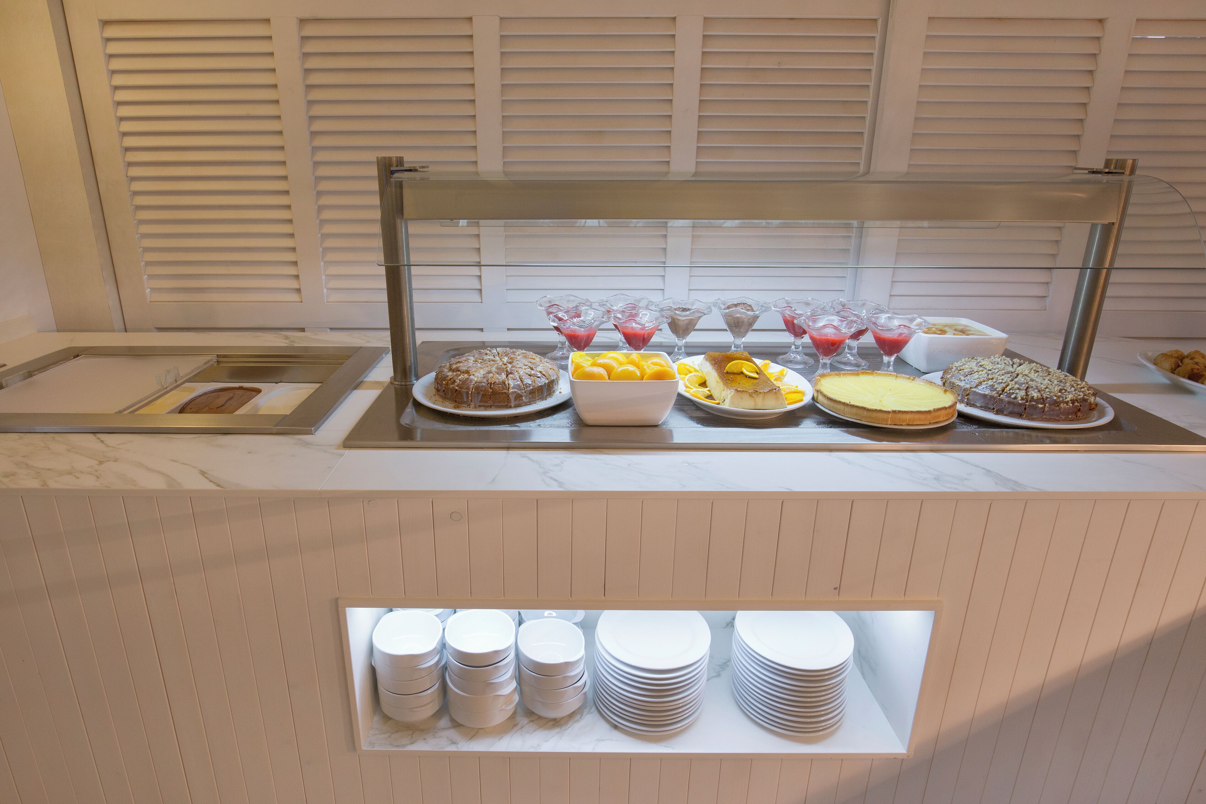 A buffet with various food items and drinks.