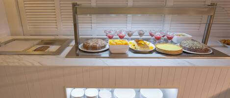 A buffet with various food items and drinks.