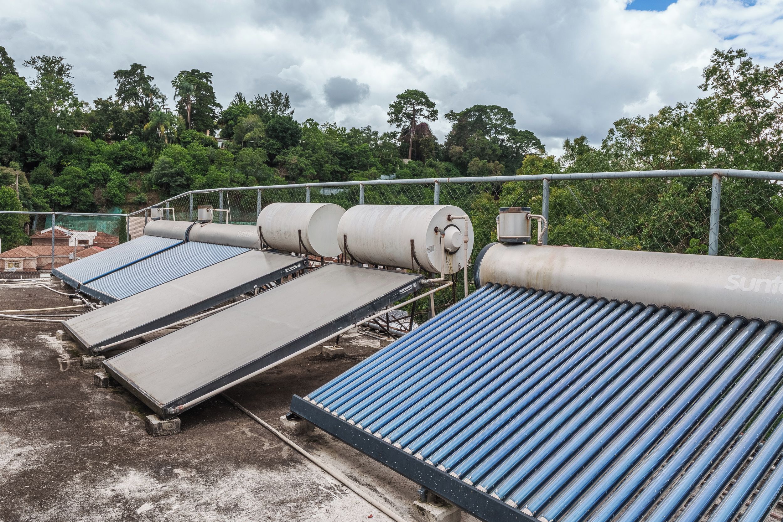 A solar thermal power plant with large cylindrical collectors and flat, blue pipes.