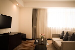 Superior Suite, 1 Bedroom, Refrigerator | Living area | Flat-screen TV, pay movies