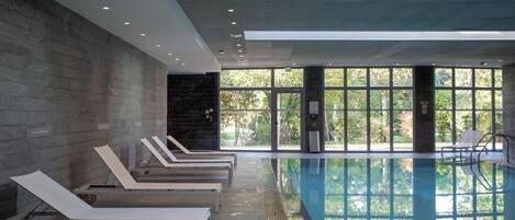 Indoor pool, open 9:00 AM to 9:00 PM, pool loungers