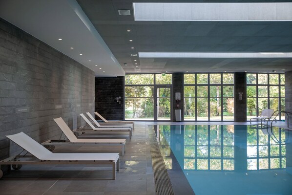 Indoor pool, open 9:00 AM to 9:00 PM, pool loungers