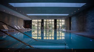Indoor pool, open 9:00 AM to 9:00 PM, pool loungers