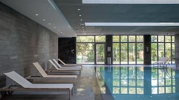 Indoor pool, open 9:00 AM to 9:00 PM, pool loungers