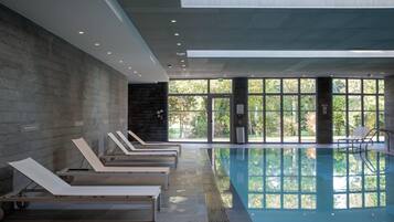 Indoor pool, open 9:00 AM to 9:00 PM, pool loungers