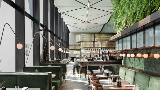 A restaurant interior with booths, tables, hanging lights, and a bar area. - Novotel Auckland Airport (Auckland)