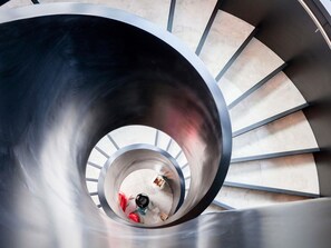 A spiral staircase with a metallic finish and a view of the floor below. - Novotel Auckland Airport (Auckland)
