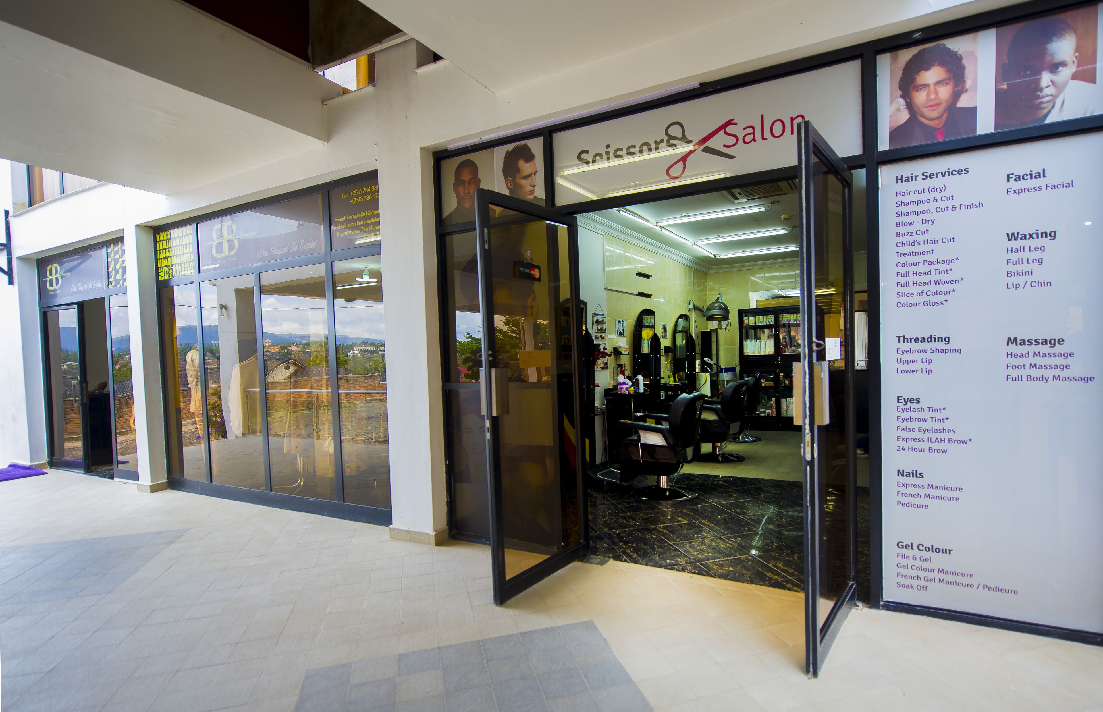 A salon with a glass entrance, visible interior including a chair and salon equipment, and a list of services on the right side.