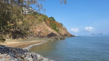 Beach nearby, white sand, beach umbrellas, beach towels