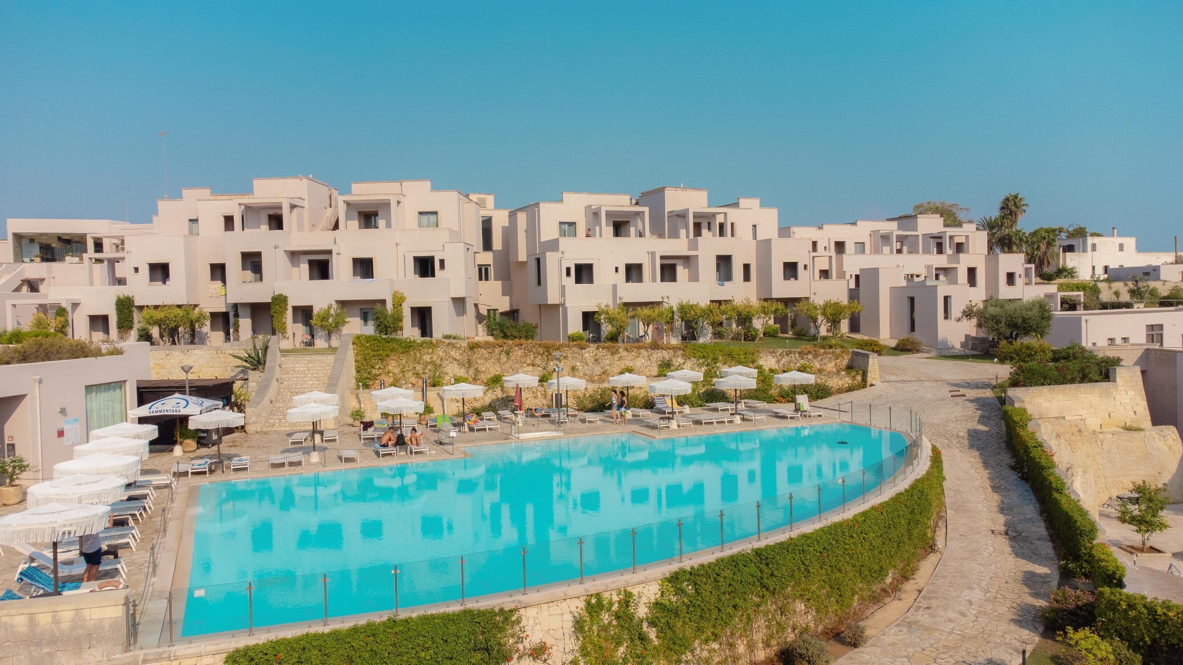 Una piscina cubierta, una piscina al aire libre de temporada, sombrillas