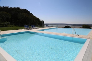 Seasonal outdoor pool, open 10 AM to 7 PM, pool umbrellas, pool loungers