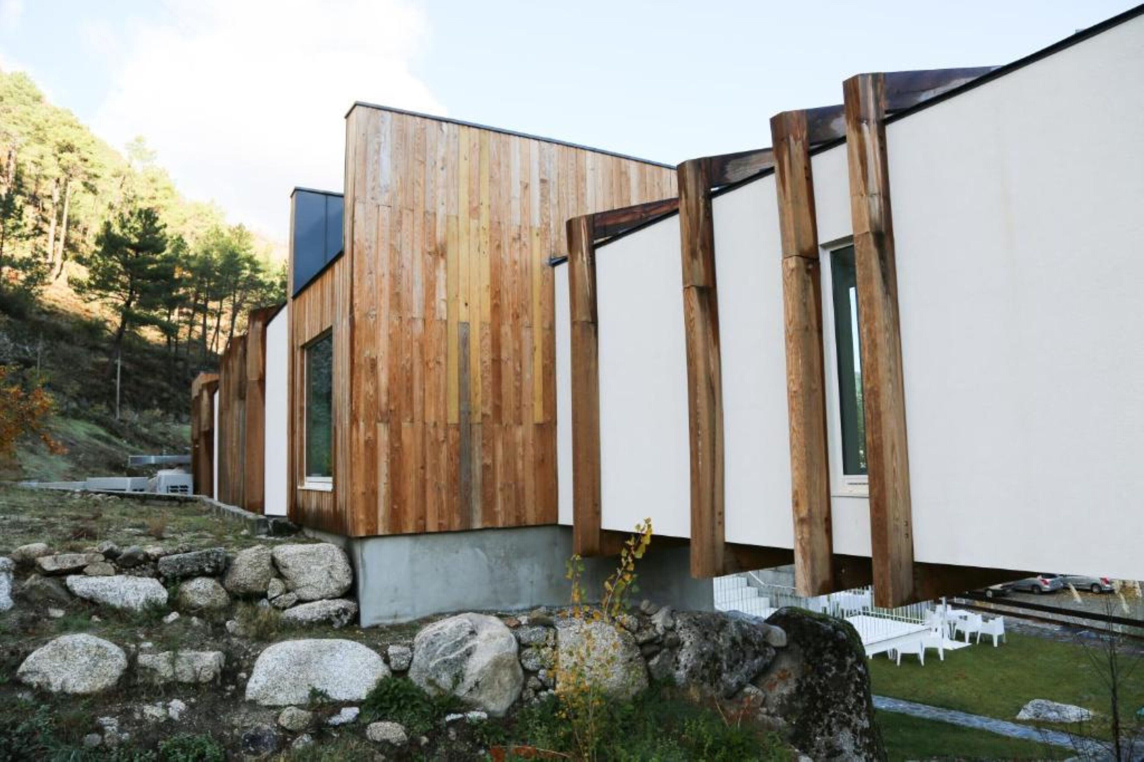 A modern building with a wooden facade and large windows.