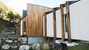 A modern building with a wooden facade and large windows.