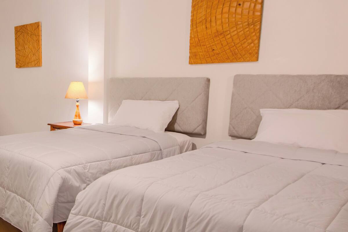 2 twin beds garden view | 1 bedroom, frette italian sheets, premium bedding, down duvets