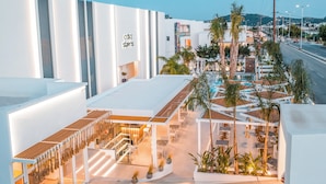 A modern hotel with a rooftop pool area, outdoor seating, and a prominent 'Costa' sign. - Casa Stavris (Rhodes)