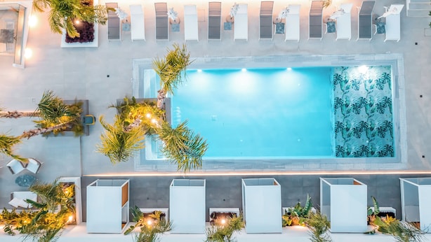 An aerial view of a swimming pool with lounge chairs and potted plants around it. - Casa Stavris (Rhodes)