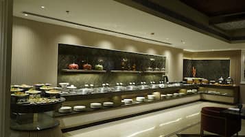 A buffet setup with multiple food stations and seating areas.