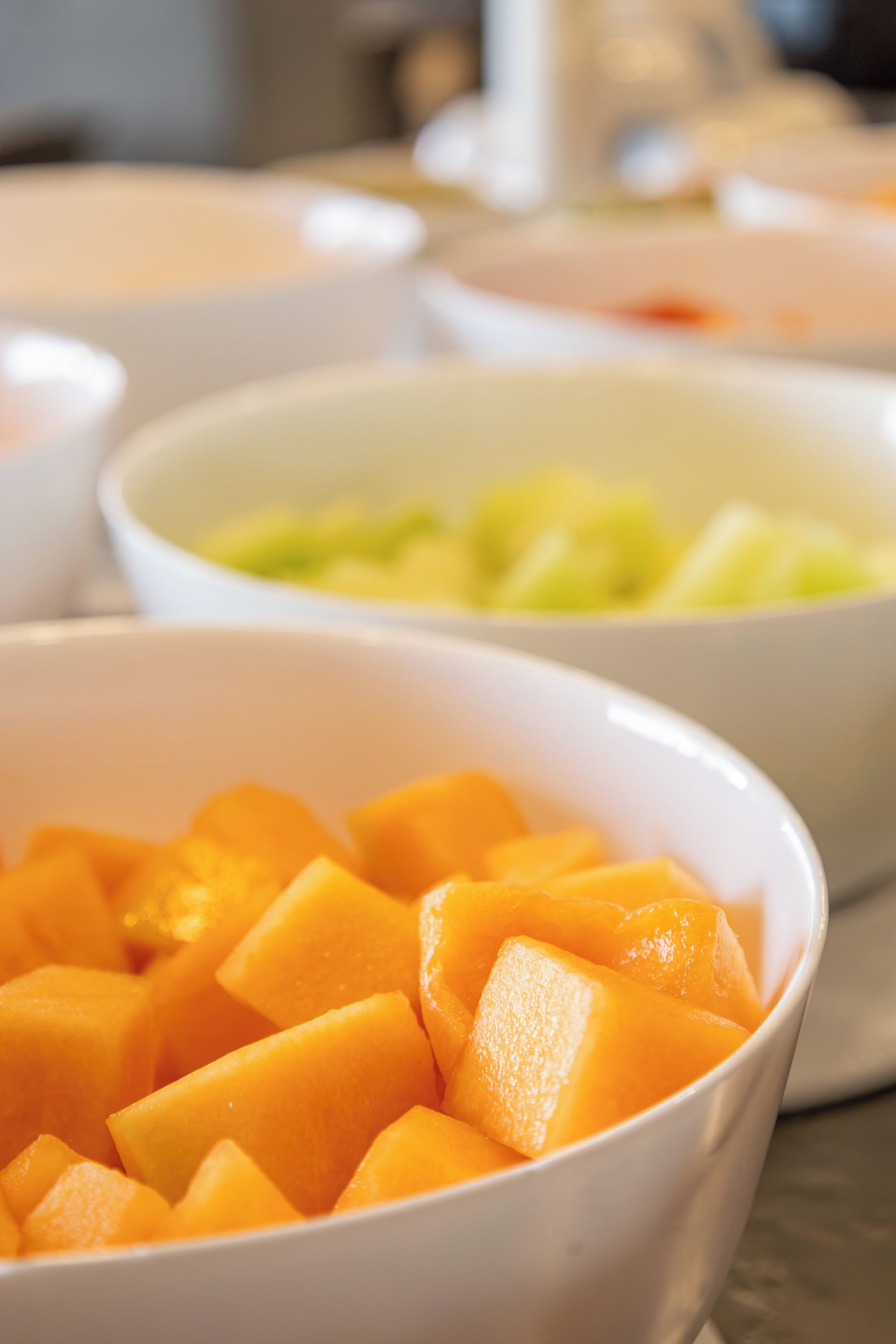 A table with multiple bowls containing different food items.