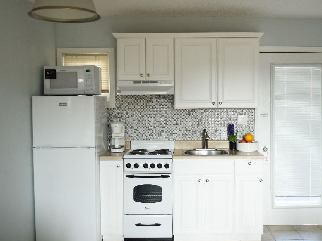 full-sized fridge, microwave, stovetop, cookware/dishes/utensils