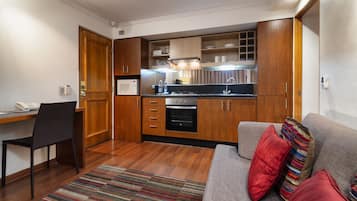 Standard Apartment, 1 Queen Bed | Living area | 32-inch TV with cable channels