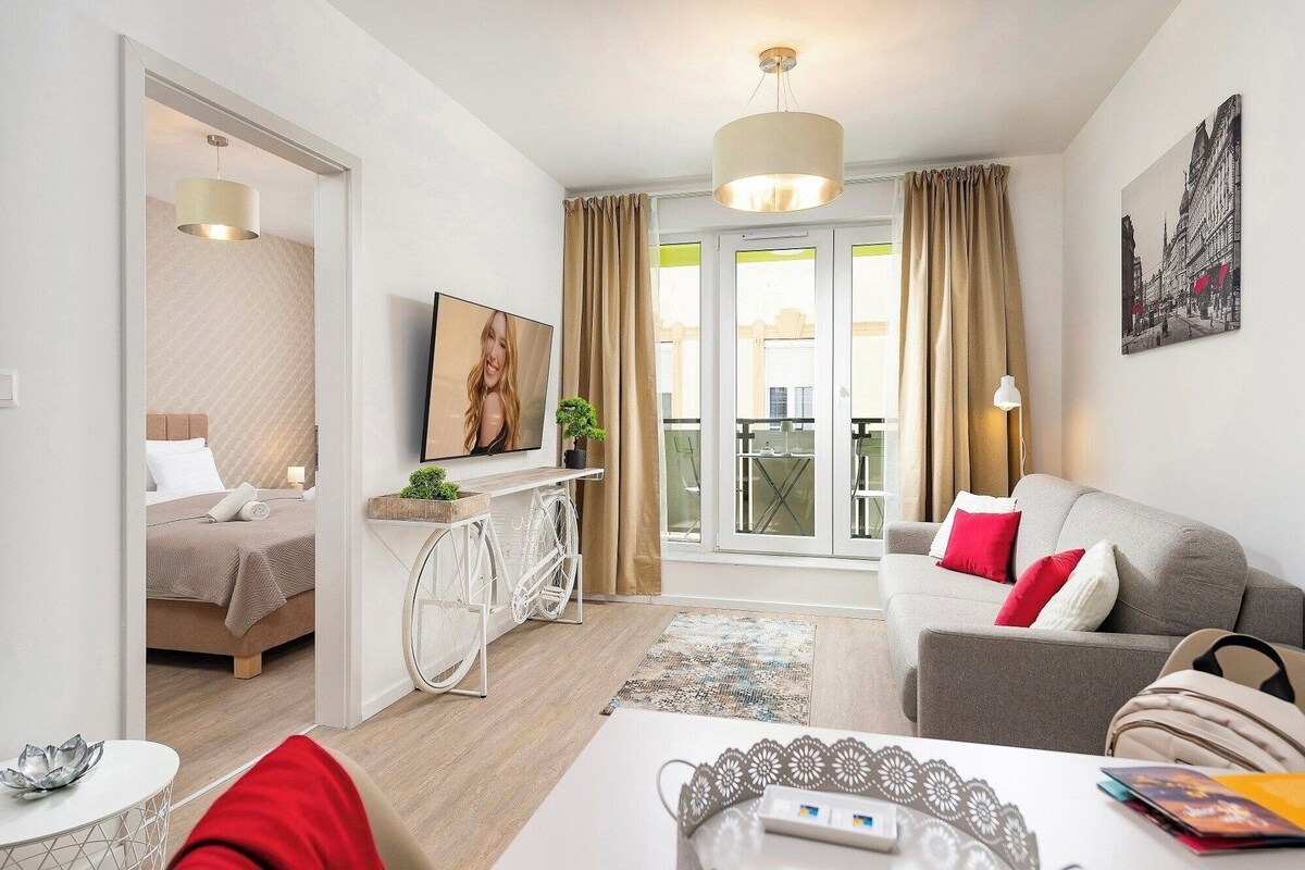 A modern living room with a sofa, a dining table, and a wheelchair-accessible console table.