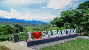 A sign with "I ♥ SARAHIA" and a scenic view of hills and greenery. - Sabah Tea Resort (Ranau)