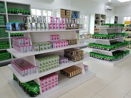 A retail store with multiple shelves stocked with various tea products.