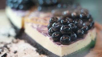 Una porción de pastel con capas y arándanos encima.