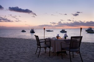 On the beach, white sand, sun loungers, beach umbrellas