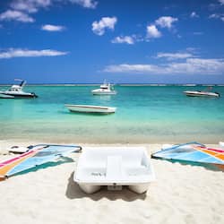 On the beach, white sand, sun loungers, beach umbrellas