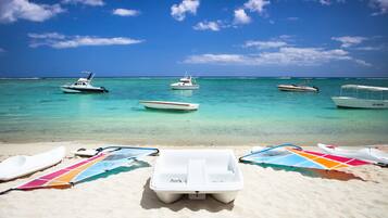 On the beach, white sand, sun loungers, beach umbrellas